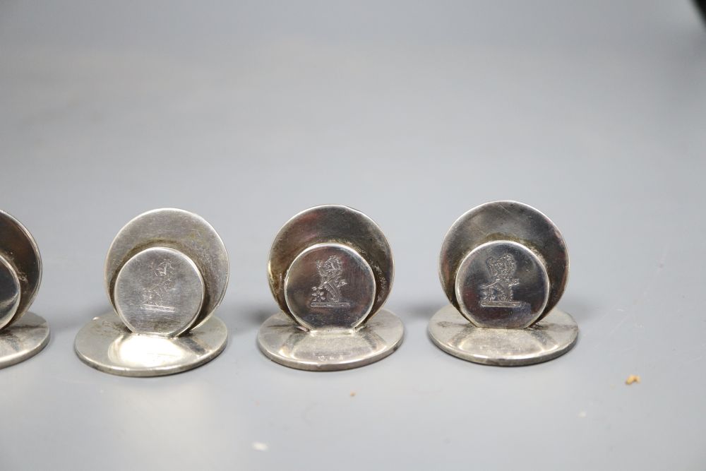 A set of six Edwardian silver menu holders, Sampson Mordan & Co, Chester, 1909, 27mm, with engraved crest.